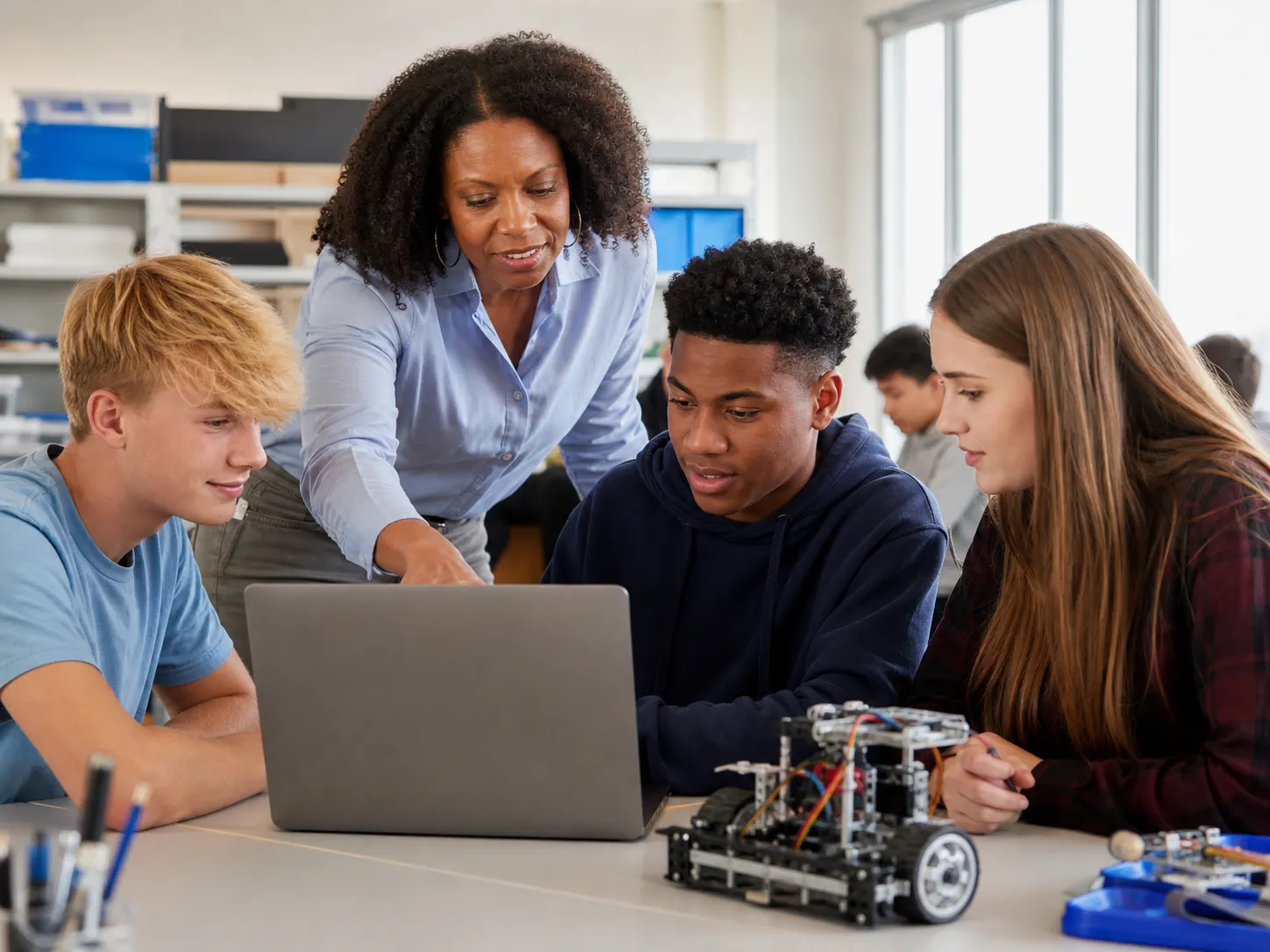 Students and an educator collaborating in an AI learning session